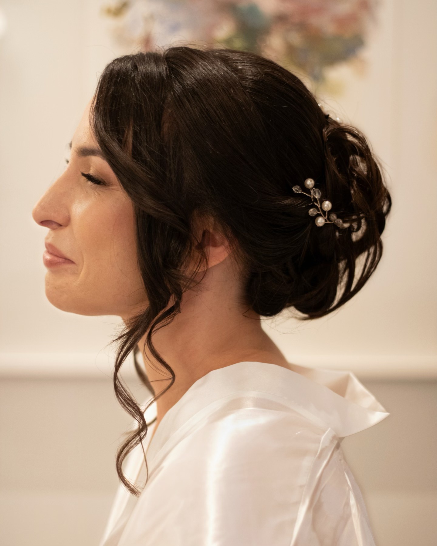 Elegant updo with pearl hair accessory for weddings